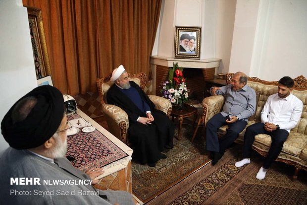 Rouhani visits families of martyrs, war veteran