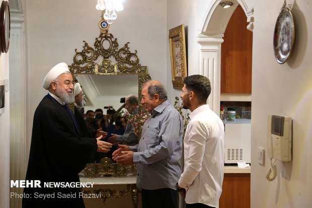 Rouhani visits families of martyrs, war veteran