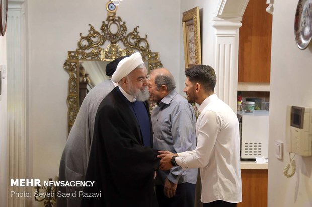 Rouhani visits families of martyrs, war veteran