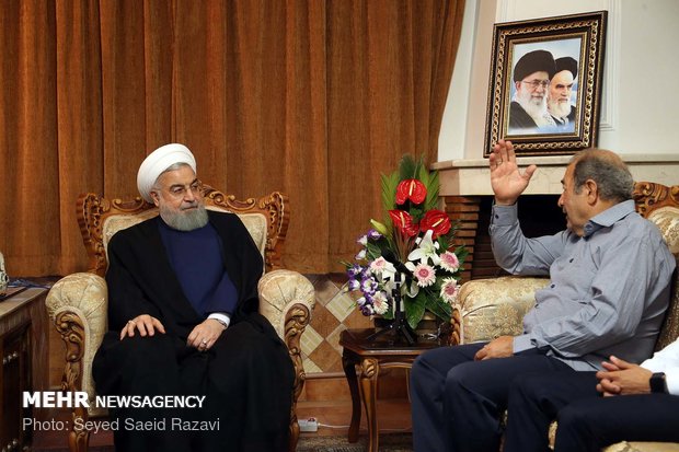 Rouhani visits families of martyrs, war veteran