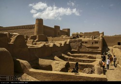 People visit the ruins of Arg-e Rayen, an ancient adobe citadel in Kerman province, southeast Iran.