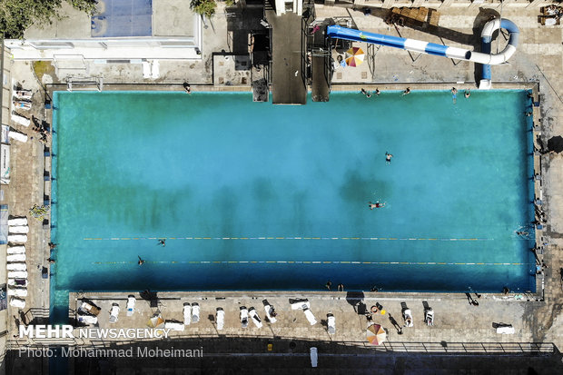 Tehraners enjoy an outdoor swimming pool