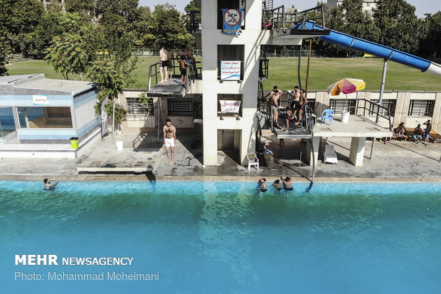 Tehraners enjoy an outdoor swimming pool