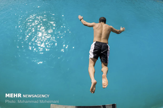 Tehraners enjoy an outdoor swimming pool