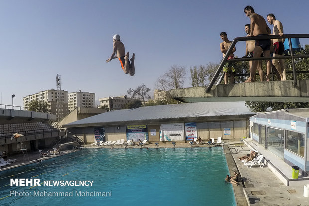 Tehraners enjoy an outdoor swimming pool