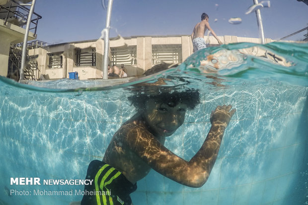 Tehraners enjoy an outdoor swimming pool