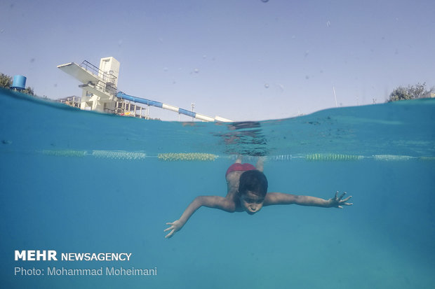 Tehraners enjoy an outdoor swimming pool