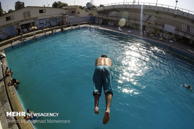 Tehraners enjoy an outdoor swimming pool