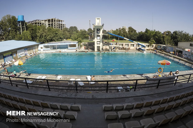 Tehraners enjoy an outdoor swimming pool