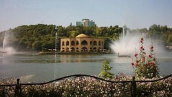 A view of Elgoli Park in Tabriz. Its fairground surrounds an artificial lake, in the middle of which stands tall a photogenic palace dating from the Qajar era.