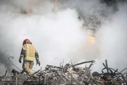 A fireman searching through the debris of the Plasco building (Photo by Majid Asgaripour/Tehran Times)