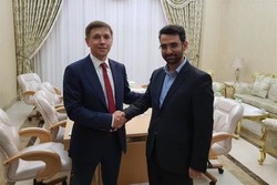 Iran’s ICT minister Mohammad Javad Azari Jahromi (R) shakes hand with his Russian counterpart Konstantin Noskov during a meeting in Ashgabat, Turkmenistan on Wednesday  