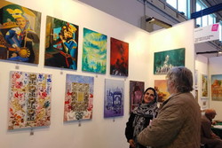 Iranian artist Zahra Davari speaks to a visitor at the pavilion of the Tazhib Cultural Art Institute during the Arte Padova on November 16, 2018. (IRNA) 