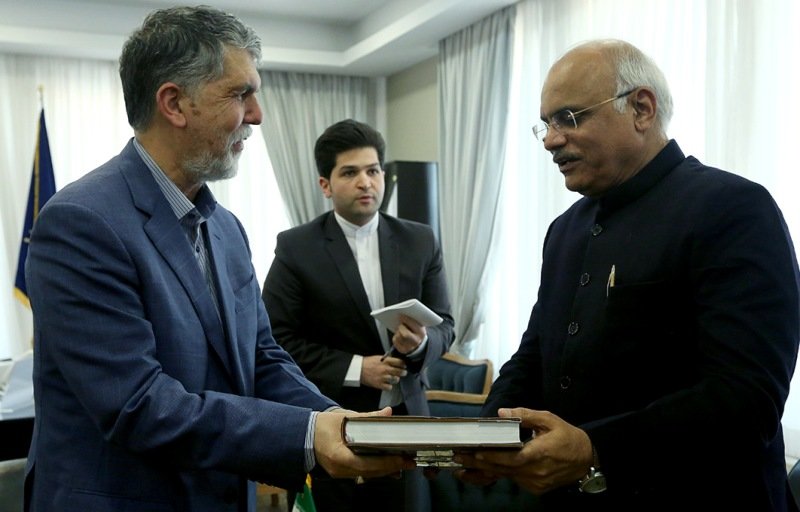 Iranian Culture Minister Seyyed Abbas Salehi presents ICCR president Vinay Prabhakar Sahasrabuddhe a book during his visit to Tehran on December 3, 2018.