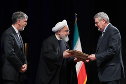 President Hassan Rouhani honors a scholar during the 36th Iran’s Book of the Year Awards at Tehran’s Vahdat Hall on February 5, 2019. Culture Minister Seyyed Abbas Salehi is also seen in the photo. (P