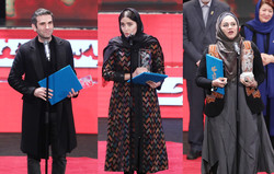 actors Hutan Shakiba (L) and Elnaz Shakerdoost and director Narges Abyar after accepting their awards for “The Night When the Moon Was Full” during the 37th Fajr Film Festival at Tehran’s Milad Tower