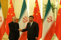 Chinese President Xi Jinping and Iranian Parliament speaker Ali Larijani