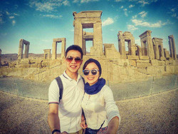  A Japanese couple pose for a selfie with ruins of Persepolis in the background while visiting the ancient city in southern Iran.