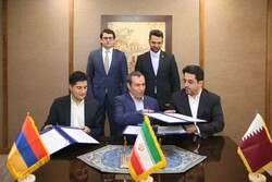 Representatives from Qatar (r), Iran (c) and Armenia (l) exchange documents of the agreement in the presence of Azari Jahromi (standing r) and Arshakyan