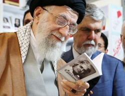 Leader of the Islamic Revolution Ayatollah Seyyed Ali Khamenei glances at “A Selection of Ahmad Shamlu’s Poems” at the pavilion of Morvarid Publications at the 32nd Tehran International Book Fair on A