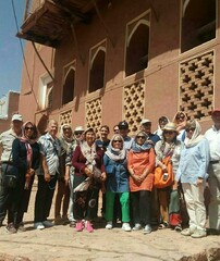 Foreign travelers pose for a photo during their visit to Abyaneh, an ancient village in Isfahan province.