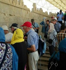 International travelers visit bas-relief carvings of the eastern staircase of Apadana, a ruined palace in the UNESCO-tagged Persepolis, southern Iran.