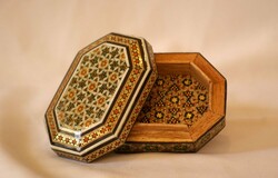 Khatam is an ancient Persian technique of inlaying; a version of marquetry where art forms are made by decorating the surface of wooden articles with delicate pieces of wood, bone and metal precisely-cut intricate geometric patterns.