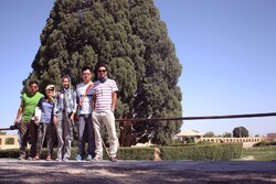 Tourist guide and international travelers pose for a photo during their visit to Sarv-e Abarkuh (“Cypress of Abarkuh”), which is estimated to date 4,500 years, in Yazd province, Iran.