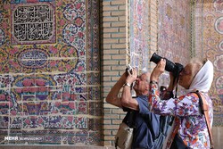International travelers take photos of the 19th-century Nasir al-Molk Mosque, a tourist destination in Shiraz, southern Iran.