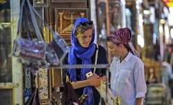 File photo: Foreign travelers browse handicrafts at a Tehran crafts exhibit.
