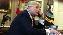 U.S. President Donald Trump speaking on the phone in the Oval Office of the White House in an undated photo.