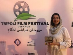 Director Mona Zandi-Haqiqi accepts a special jury award for her drama “African Violet” at the 6th Tripoli Film Festival in Lebanon on June 19, 2019.