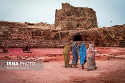 People tour the Portuguese Castle of Hormuz in the Persian Gulf