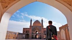  File photo: A foreign traveler visits the historical Agha Bozorg Mosque in Kashan, central Iran.