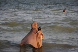 Swimming in Persian Gulf to escape summer heat