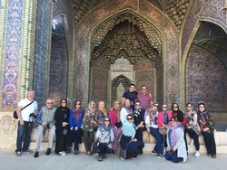 Travelers pose for a photo during their visits to the atmospheric Nasir al-Molk Mosque in Shiraz, southern Iran.