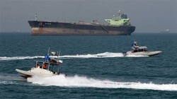 In this file picture, Iranian speedboats drive in front of an oil tanker at the port of Bandar Abbas in the Persian Gulf. (Photo by AFP)