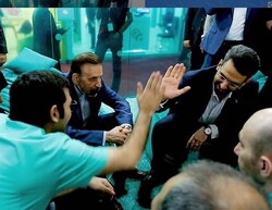 ICT Minister Mohammad Javad Azari Jahromi gives five to an entrepreneur during his visit to ELECOMP 2019 on Thursday