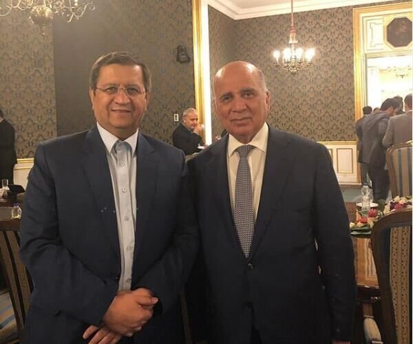 Governor of Central Bank of Iran (CBI) Abdolnasser Hemmati (L) Iraqi Finance Minister Fuad Mohammed Hussein