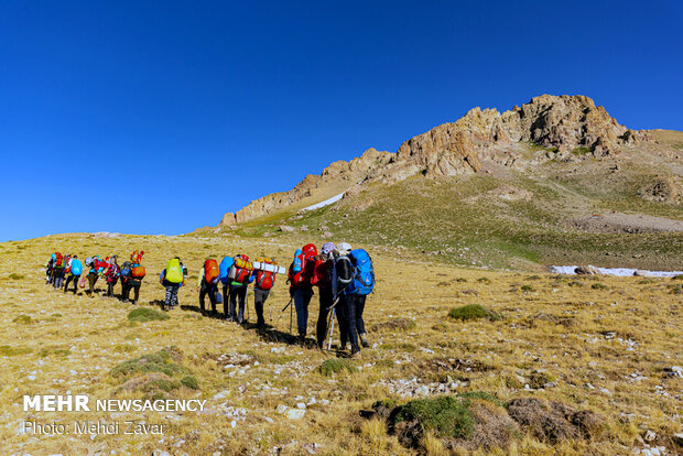 Climbing Buzsina mountain in summer