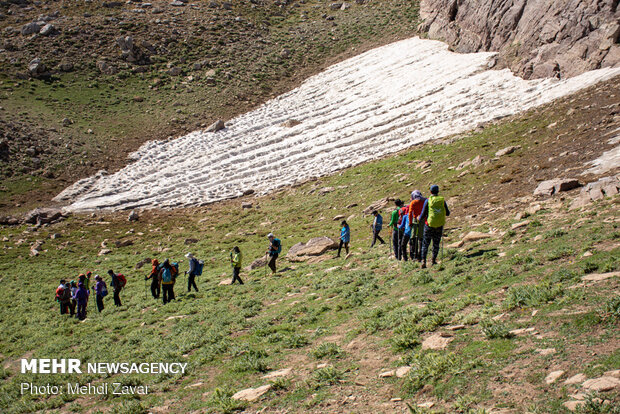 Climbing Buzsina mountain in summer