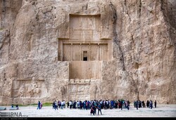 File photo: People visit Naqsh-e Rostam, an Achaemenid-era necropolis, in Fars province, southern Iran. Mostly referred to as “a must-see” destination, Naqsh-e Rostam is home to several spectacular massive rock–hewn tombs and bas-relief carvings.