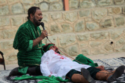 Ala’eddin Qasemi (L) and his colleague perform a tazieh in an undated photo.
