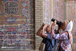 Foreign travelers take photos of the 19th-century Nasir al-Mulk Mosque, also known as the Pink Mosque, in Shiraz, southern Iran.