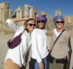 An undated photo shows foreign travelers posing for a photo in Persepolis, southern Iran.