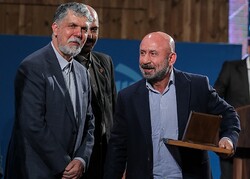 Kazem Darabi (R) receives the award in the documentation category for his memoirs “Teahouse Painting” from Culture Minister Abbas Salehi (L) during the 12th Jalal Al-e Ahmad Literary Awards in Tehran