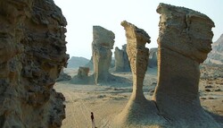  File photo depicts a man visiting giant Kaluts of Shahdad, a major part of the UNESCO-registered Lut desert, in Kerman province, southeastern Iran.