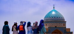 Travelers look at the polychrome dome of the Jameh Mosque of Yazd (Masjid-e-Jameh Yazd) in and undated photo. Soaring above the ancient UNESCO-tagged city, the mosque is graced with a lavishly decorated entrance portal (which is one of the highest in Iran), flanked by two raised minarets. Exquisite mosaics and tilework, intricate stucco and mirrorwork along with masterpieces of Persian calligraphy are amongst charms of the 12th-century structure to name a few.