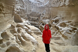 A sightseer poses for a photo during her visit to the Qeshm Geopark in the Persian Gulf, southern Iran.