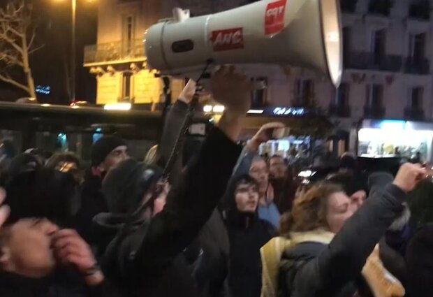 Macron rushed out of Paris theater after protesters try to confront him